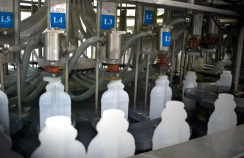A close-up shot of multiple bottles within a packaging factory