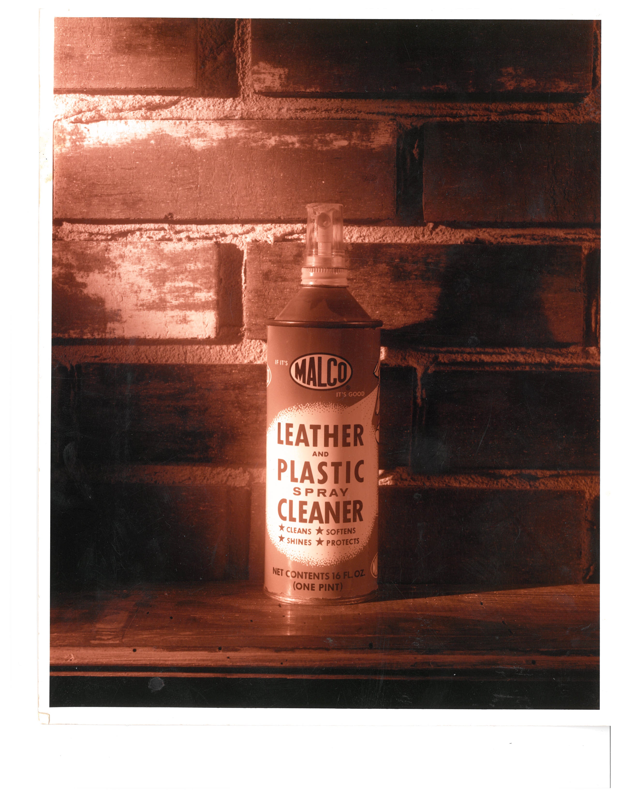 a spray can of LEATHER AND PLASTIC SPRAY CLEANEAR on a shelf