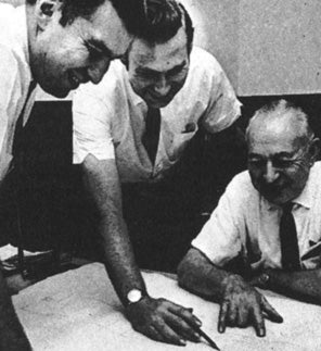 a group of men looking at a map